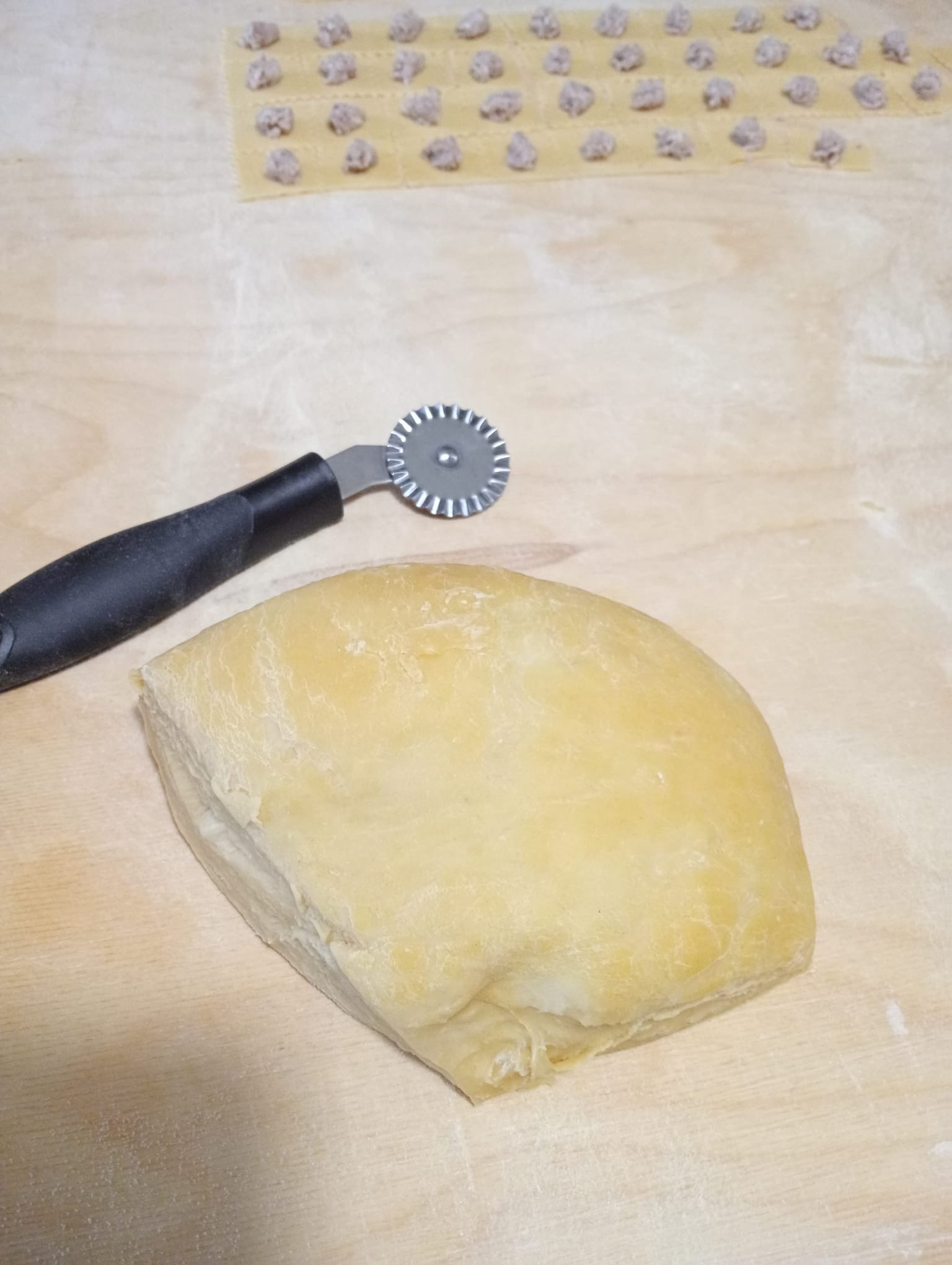 L’impasto di pasta fresca accanto alla rotella tagliapasta